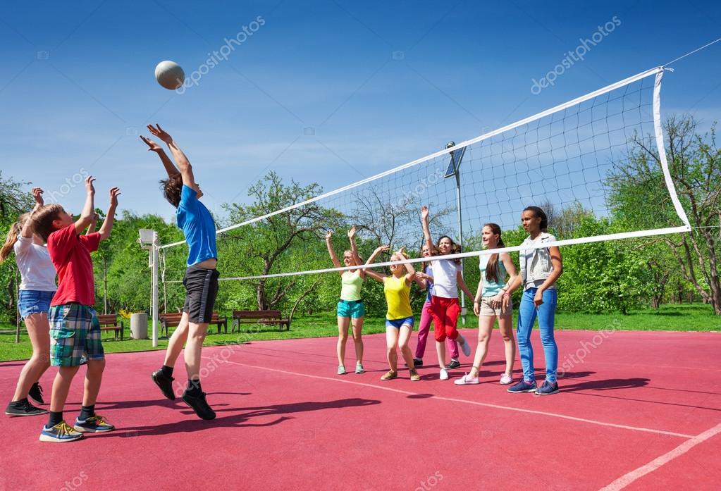 Jumping boy during volleyball game Stock Photo by ©serrnovik 77386316