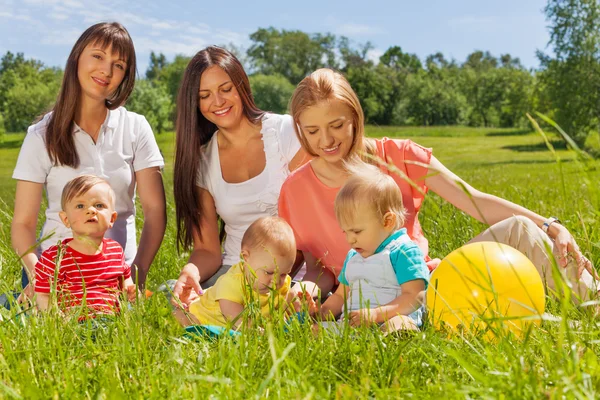 Happy mothers with cute babies — Stock Photo, Image
