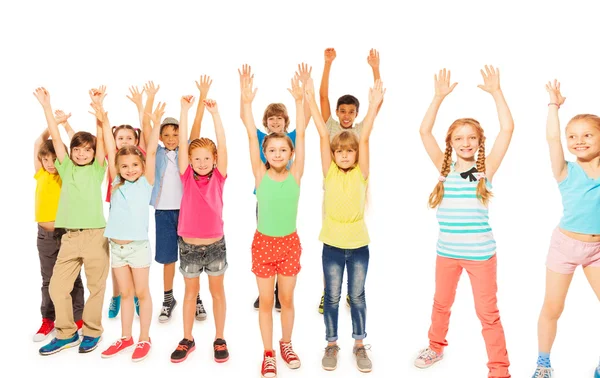 Kids stand together boys and girls rise hands — Stock Photo, Image