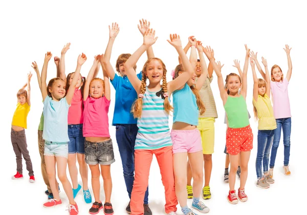 Many happy kids together raise hands up in the air — Stock Photo, Image