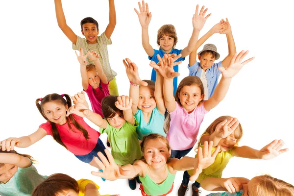 Kids jumping and lifting hands in the air — Stock Photo, Image