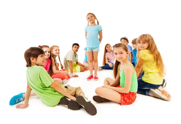 Large circle of kids and little girl in the middle — Stock Photo, Image