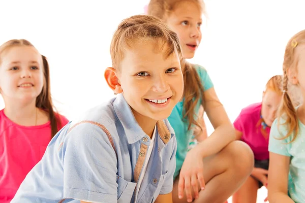 Nice boy and his mates sitting over white — Stock Photo, Image