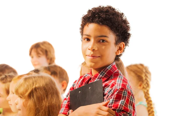 Handsome black boy with notepad and friends — Stock Photo, Image