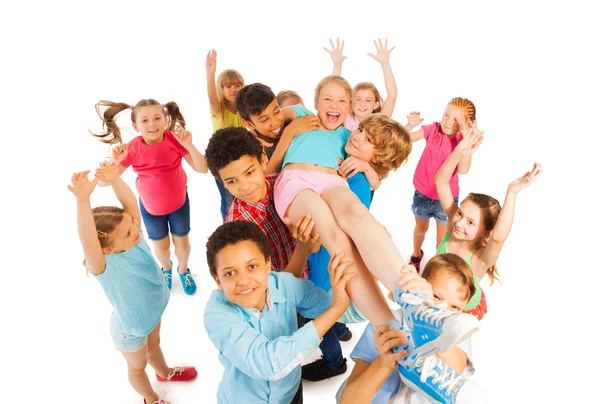 Kids lifting popular classmate and cheering — Stock Photo, Image