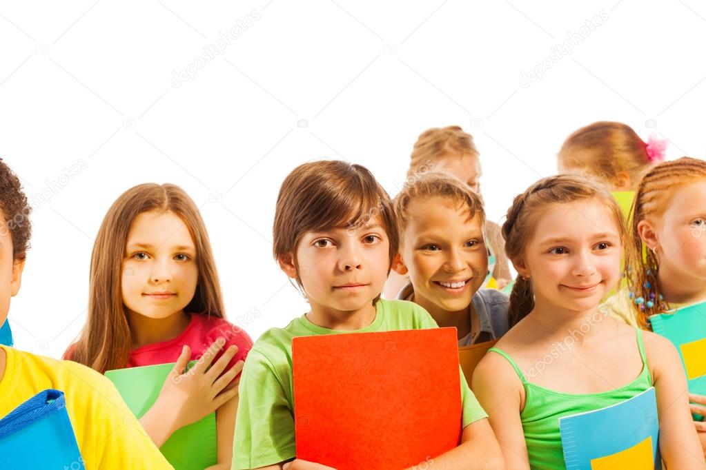 Calm kids standing with textbooks