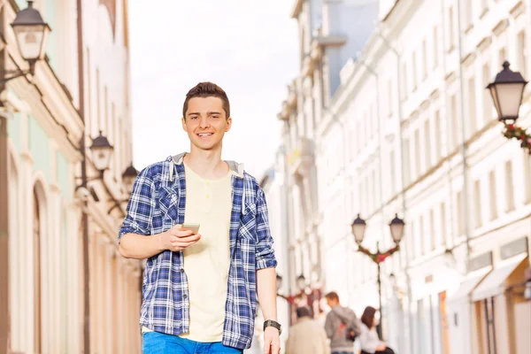 Young man with mobile phone on the street — Stock Photo, Image