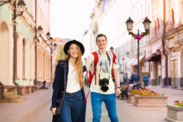 Girl holds hand of young man walking forward — Stock Photo, Image