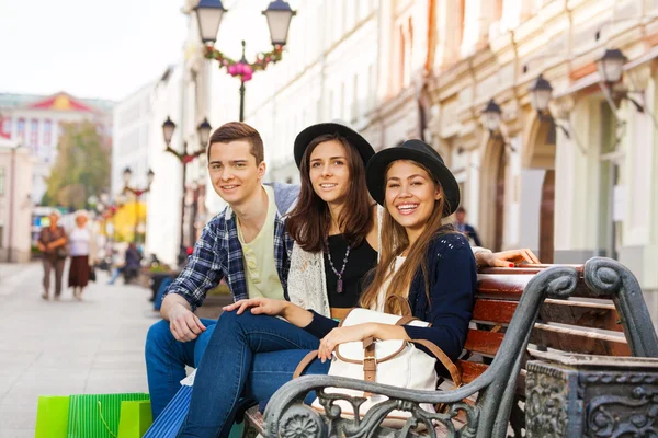 Friends sit together on bench outside — Stock Photo, Image