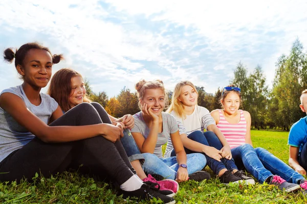 Friends sitting on grass — Stock Photo, Image