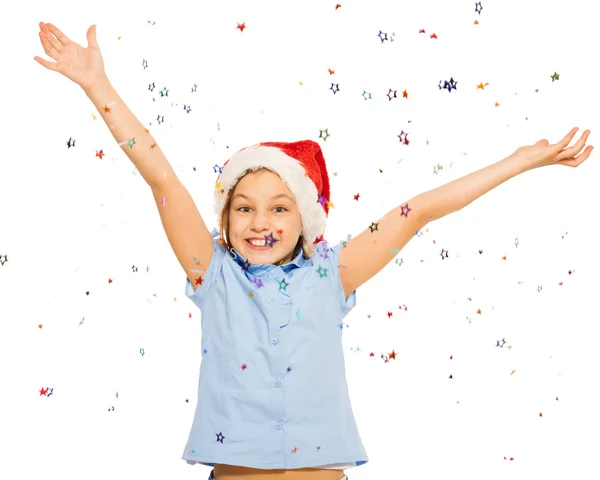 Girl in Santa cap throw confetti — Stock Photo, Image