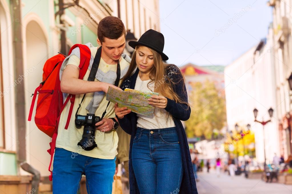 Young man and girl as tourists