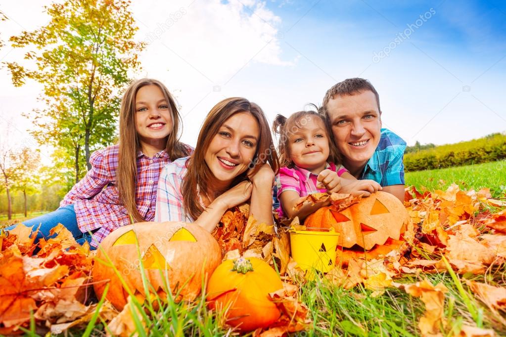 Mom dad and daughters with Halloween pumpkins