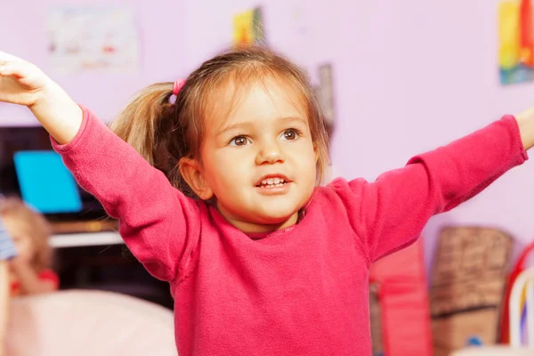 Portrait of little girl with lifted hands — Stock Photo, Image