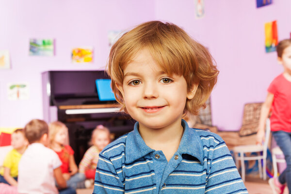 Portrait of nice boy and his friends on back