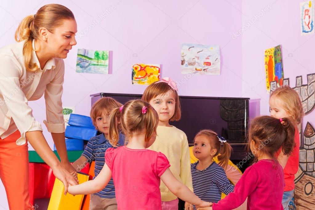 Little kids and teacher in the circle