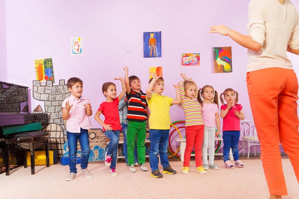 kids repeating exercise after teacher