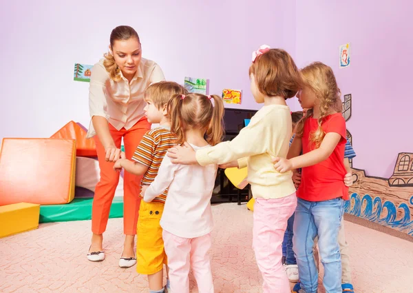 Group of kids go after each other with teacher — Stock Photo, Image
