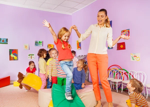 Kids run, climb around soft block in active class — Stock Photo, Image