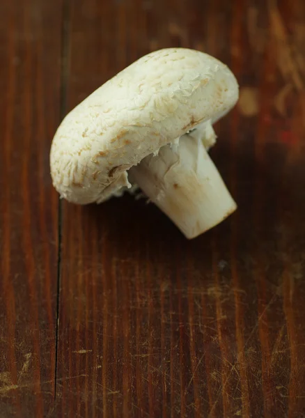 Fresh champignon on an old wooden table. Home cooking. — Stock Photo, Image