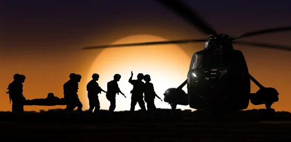 Rescue helicopter with soldiers on ground during sunset — Stock Photo, Image