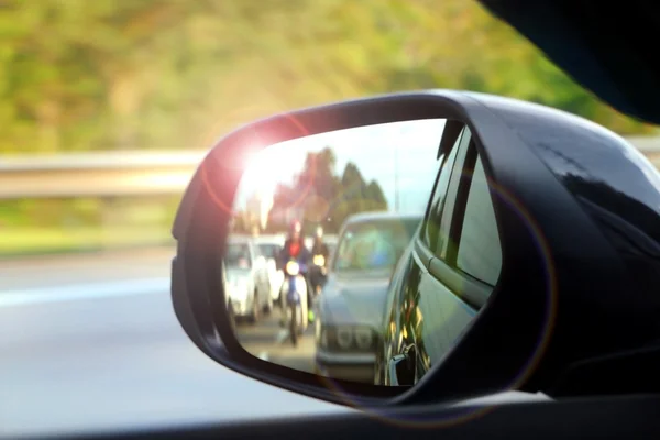 Car side mirror view with sunlight glare — Stock Photo, Image
