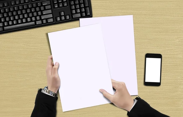 Hand holding blank paper top view — Stock Photo, Image