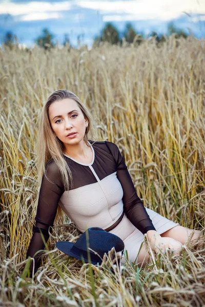 Menina posando em um campo ao pôr do sol — Fotografia de Stock