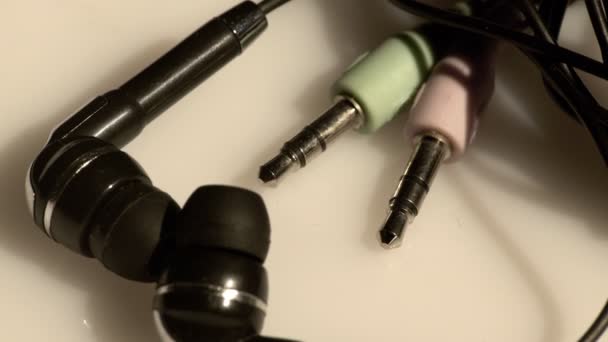 Small in-ear headphones and jacks — Stock Video