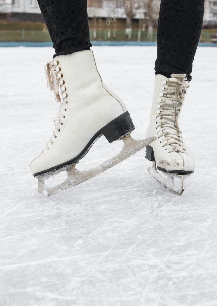 Female feet in figured fads on skating rink