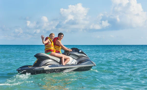 Girl and young man drive on scooter — Stock Photo, Image