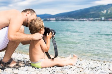 Dad with his son photographed the sea clipart