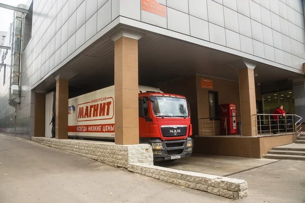 Truck MAN at unloading at the shopping center "Magnet" — Stock Photo, Image