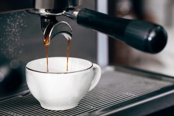 Close-up of espresso pouring from coffee machine — Stock Photo, Image