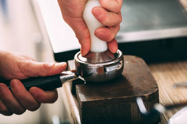 Barista pressing coffee in the machine holder — Stock Photo, Image