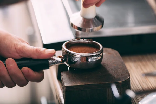 Barista pressing coffee in the machine holder — Stock Photo, Image