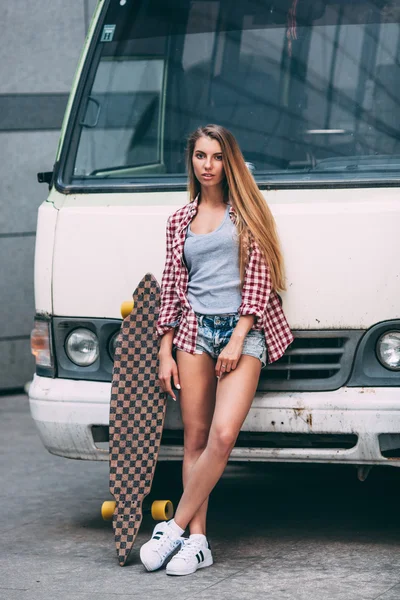 Young beautiful woman with longboard — Stock Photo, Image