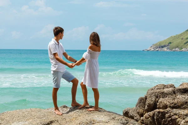 Lovely young adult couple standing on the rocks — Stock Photo, Image