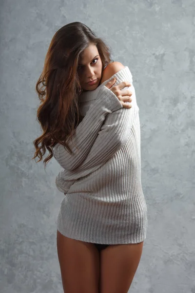 Beautiful young brunette woman in sweater — Stock Photo, Image