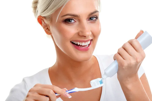 Jovencita sosteniendo cepillo de dientes y sonriendo — Foto de Stock