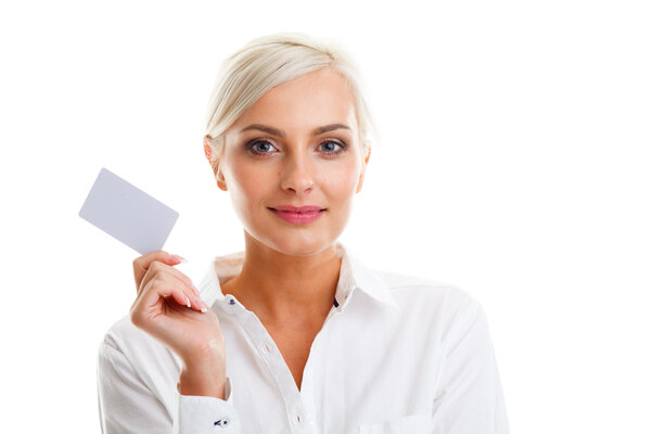 Happy blond woman showing blank credit card