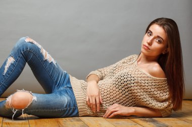 Esmer kadın ahşap yerde yatarken