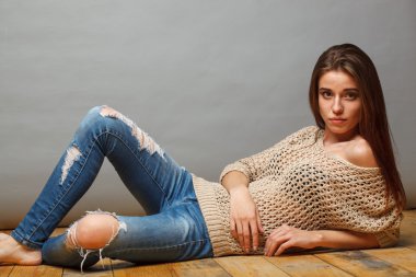 Esmer kadın ahşap yerde yatarken