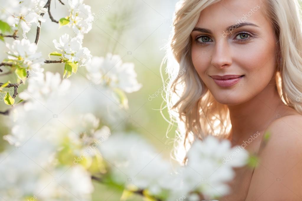 blonde woman in a flowered garden