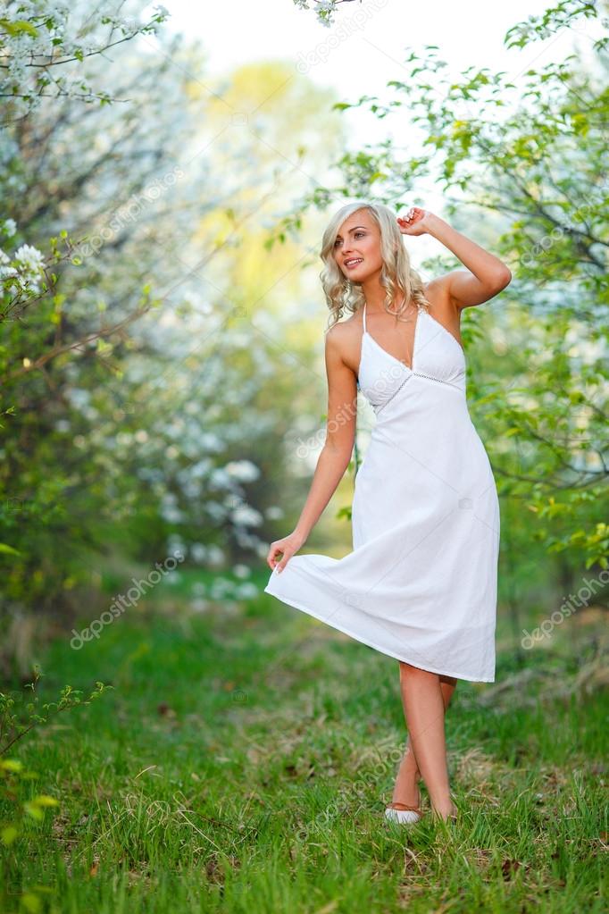 young woman walking in the spring garden