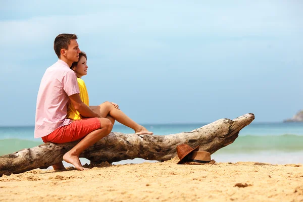 Lovely couple sitting on log — Stock Photo, Image