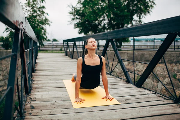 Young slim woman doing yoga — Stok fotoğraf