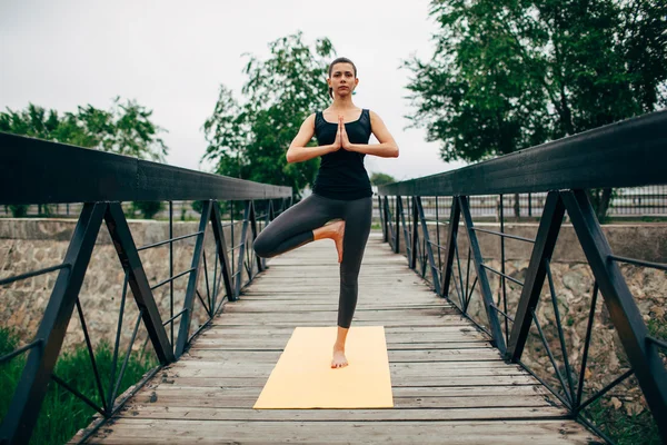 Young slim woman doing yoga — Stok fotoğraf