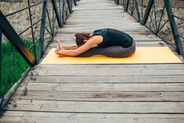 Young slim woman doing yoga — Stok fotoğraf