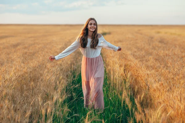 Beautiful brunette lady in wheat field at sunset — Stock Photo, Image